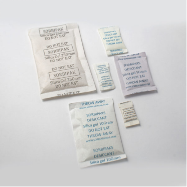White-colored silica gel desiccant packets against a white background