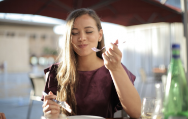 Woman smiling while consuming food